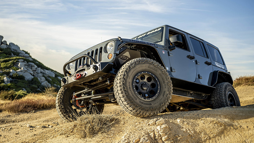 Jeep driving over rocks