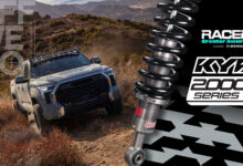 Truck driving off-road with Racer Creator Awards logo and KYB logo