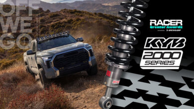 Truck driving off-road with Racer Creator Awards logo and KYB logo