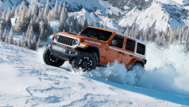 2026 Jeep Wrangler Whitecap driving uphilll through snow