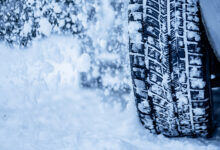 Winter tire. Detail of car tires in winter on the road