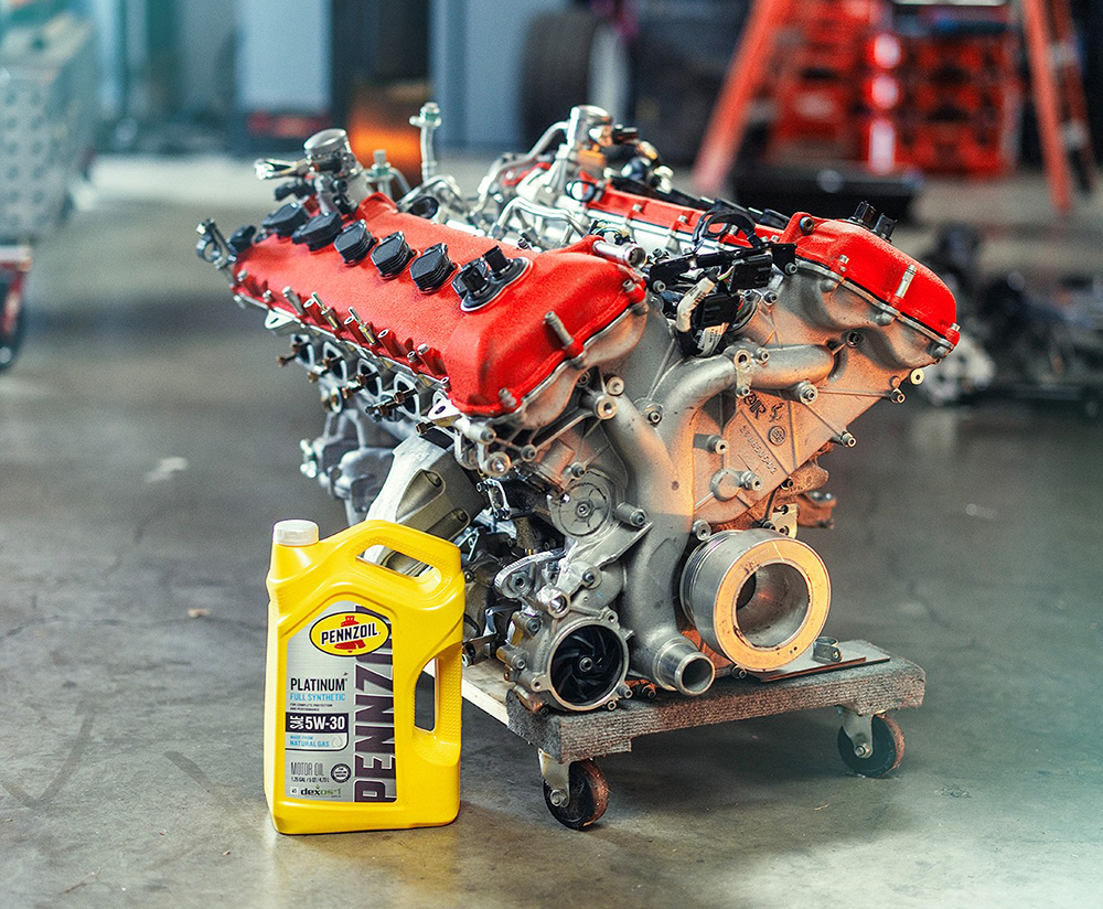 Engine on garage floor with Pennzoil bottle