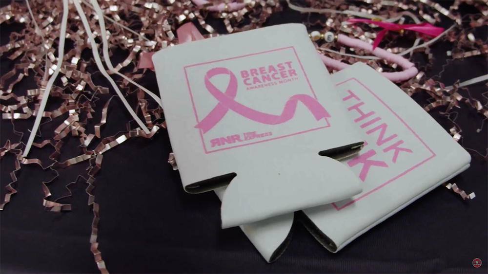 RNR Breast Cancer Awareness Koozies on table with streamers