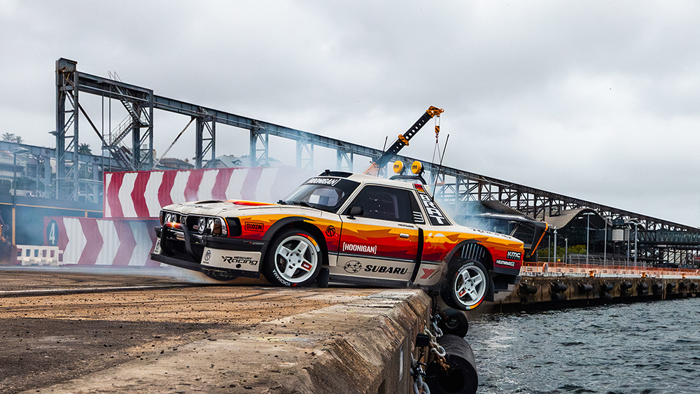 Pastrana in the “Brataroo” hanging two tires off a pier.