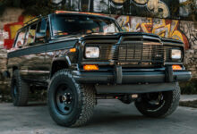 Vigilante 1979 Jeep Wagoneer restomod in front of graffiti wall