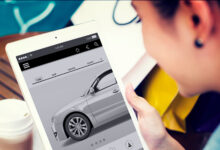 Young person buying car on tablet at coffee shop