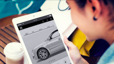 Young person buying car on tablet at coffee shop