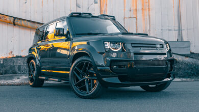Defender 110 P525 V-8 in front of old building
