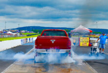 Diesel pickup truck smoking tires on drag strip