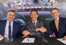HARMAN and ZF Group executives shake hands after signing agreement