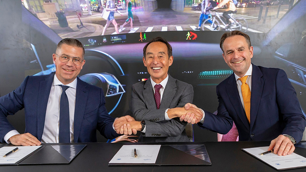 HARMAN and ZF Group executives shake hands after signing agreement