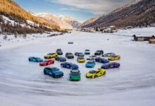 Lamborghinis parked on ice in front of mountain village