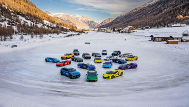 Lamborghinis parked on ice in front of mountain village