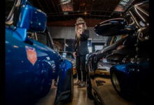 Magnus Walker pointing surrounded by Porsches