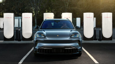 Porsche 2026 Taycan parked in front of Tesla Superchargers