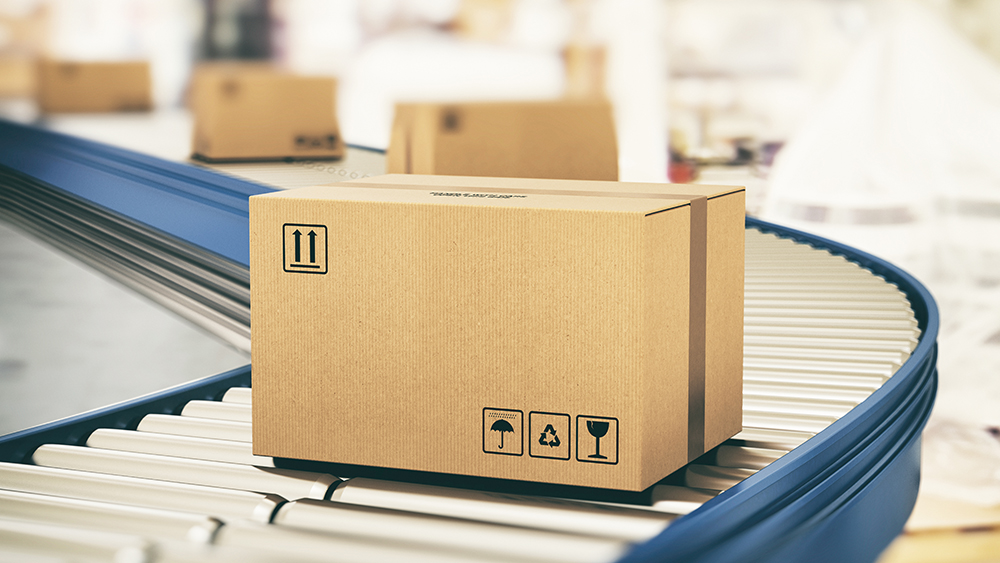 Cardboard boxes on conveyor rollers ready to be shipped by courier for distribution