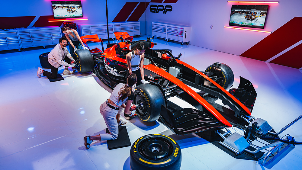 Group working as a pit crew at the Grand Prix Plaza.