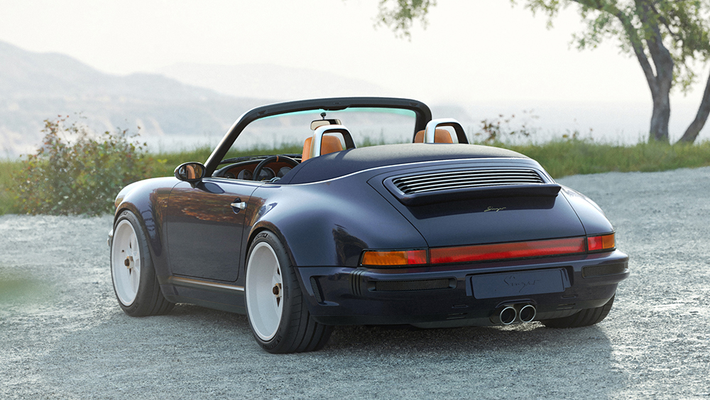 Singer Porsche 911 Carrera Cabriolet parked with mountains in the background