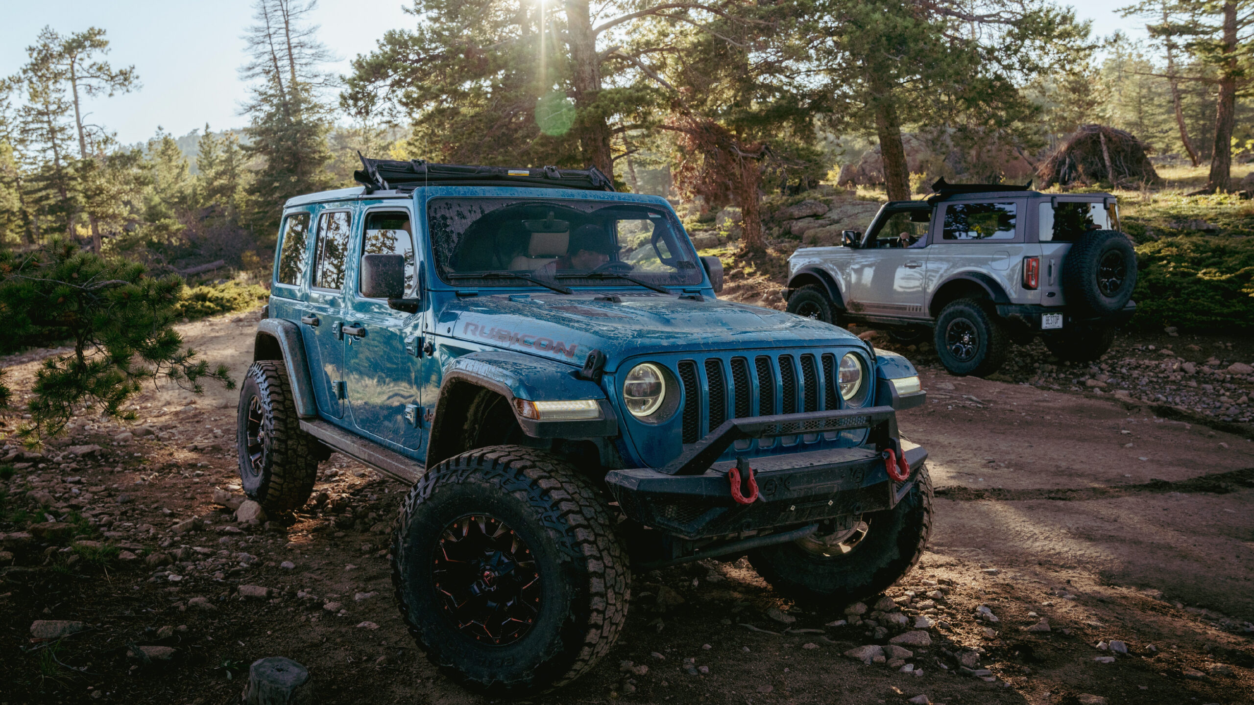 A Bronco and a Jeep featuring the Bestop Sunrider for Hardtop