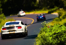 Performance cars on scenic road