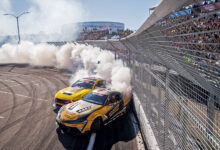 Two Formula DRIFT cars smoking tires in front of crowd
