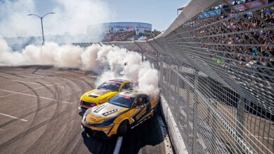 Two Formula DRIFT cars smoking tires in front of crowd