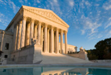 The front of the US Supreme Court in Washington, DC, at dusk.