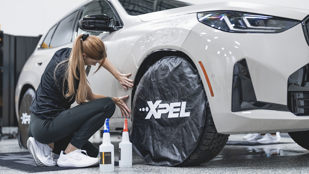 Tech applying PPF to a car