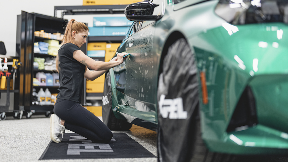 Tech applying PPF to a car