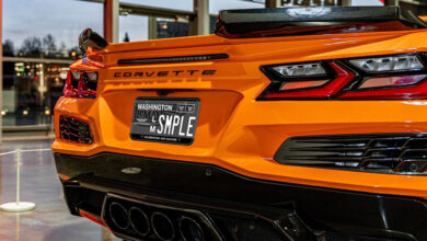 A sample version of the approved design for LeMay – America's Car Museum's custom license plate on an orange C8 Corvette.