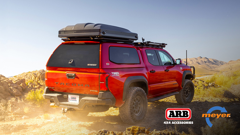 The ARB Ascent Truck Cap on a truck driving on dirt road
