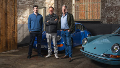 Randy Nonnenberg with James Turner and Rory Jack from Sports Purpose standing in front of two Porsches in old building