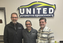 Greg Vogel, Steve Waters (operations manager) & Josh Poulson in front of UAE sign on wall