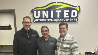 Greg Vogel, Steve Waters (operations manager) & Josh Poulson in front of UAE sign on wall