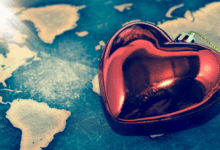 Heart charm sitting on global map