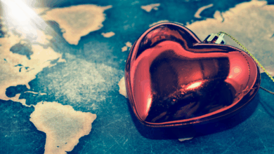 Heart charm sitting on global map