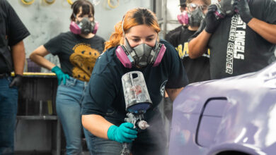Woman wearing mask and spray painting car