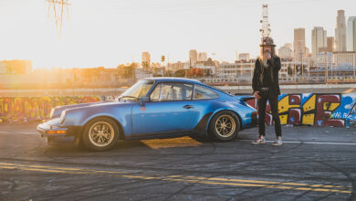 Magnus Walker next to Porsche in front of city skyline