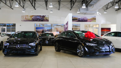 Mercedes-Benz car dealership interior with two black cars
