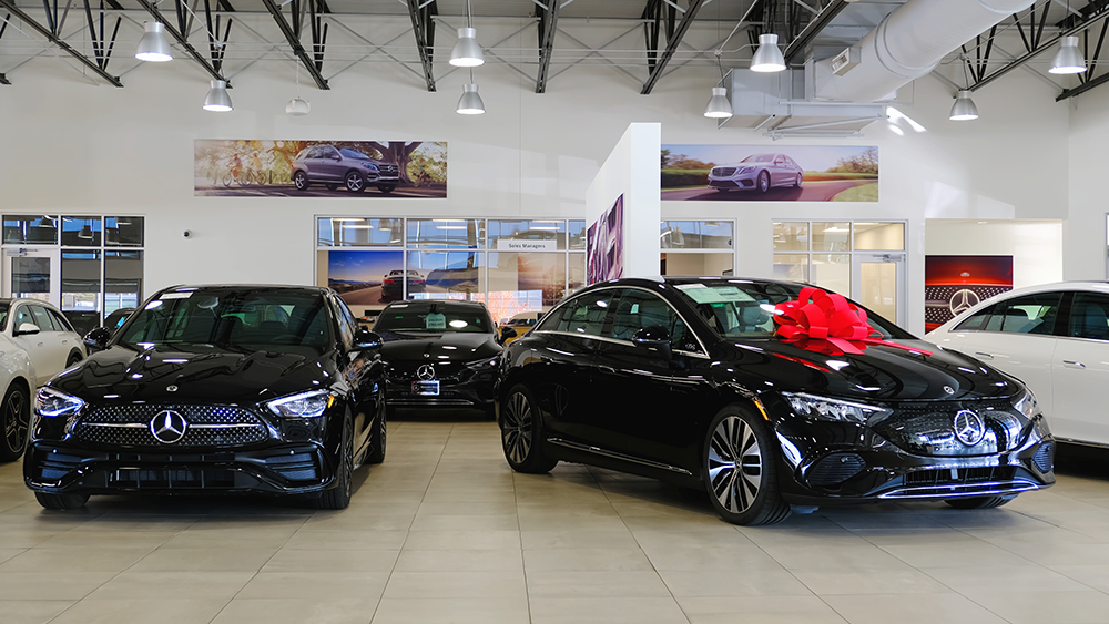 Mercedes-Benz car dealership interior with two black cars