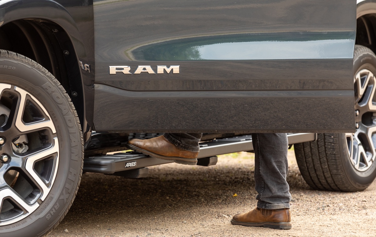 off-road racks lippert aries man steps on running board on ram pickup