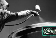 Person spray painting roof of car