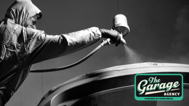 Person spray painting roof of car