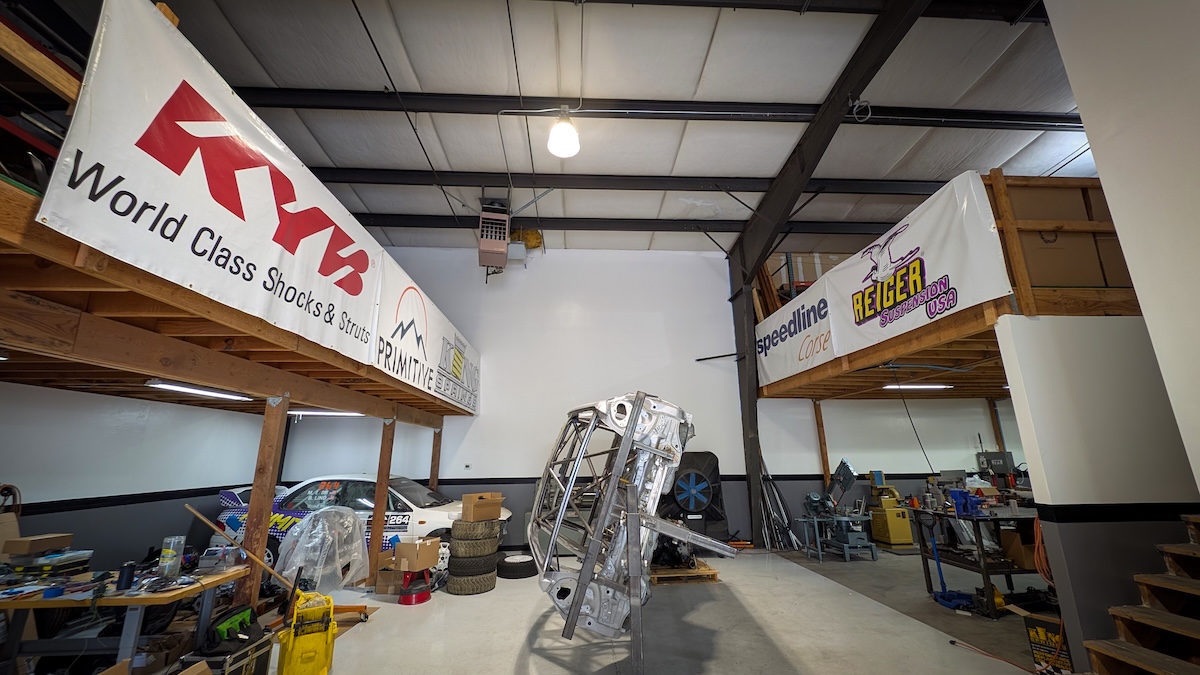 primitive racing rally car frame tilted in shop