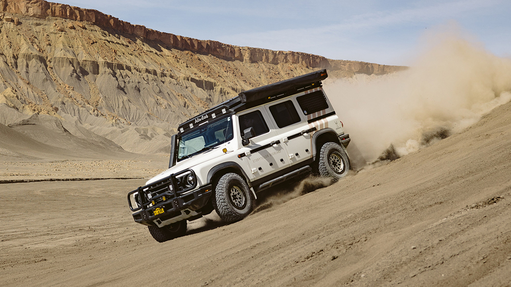 Storyteller Overland Grand Bohemain driving down dirt hill