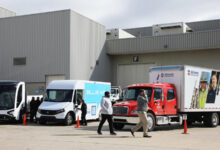 Row of work trucks in front of building