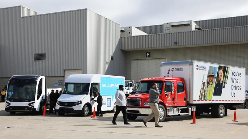Row of work trucks in front of building