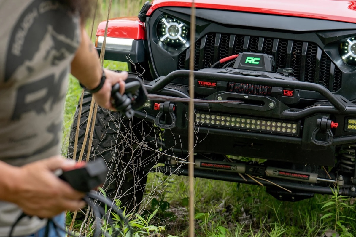 winches rough country red jeep front with hand pulling line