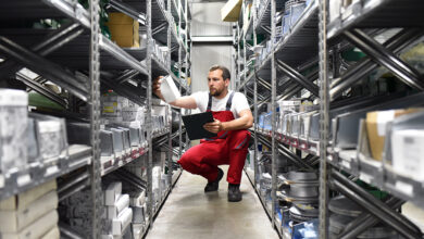 Worker in a warehouse looking for car parts