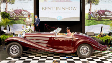Best In Show winner William Lyon sitting in 1937 Mercedes Benz 540K Special Roadster on winner's block